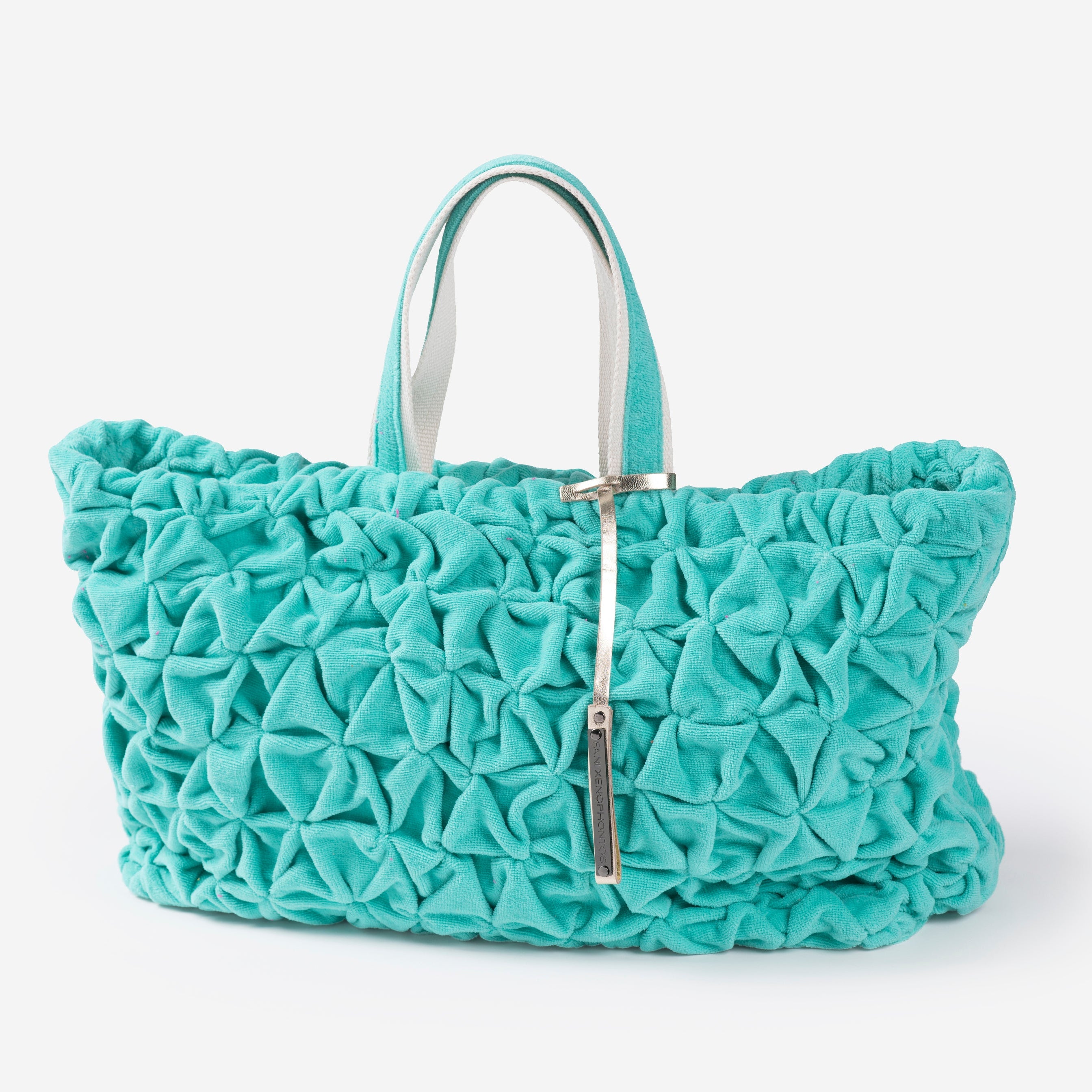Turquoise textured beach bag on a white background