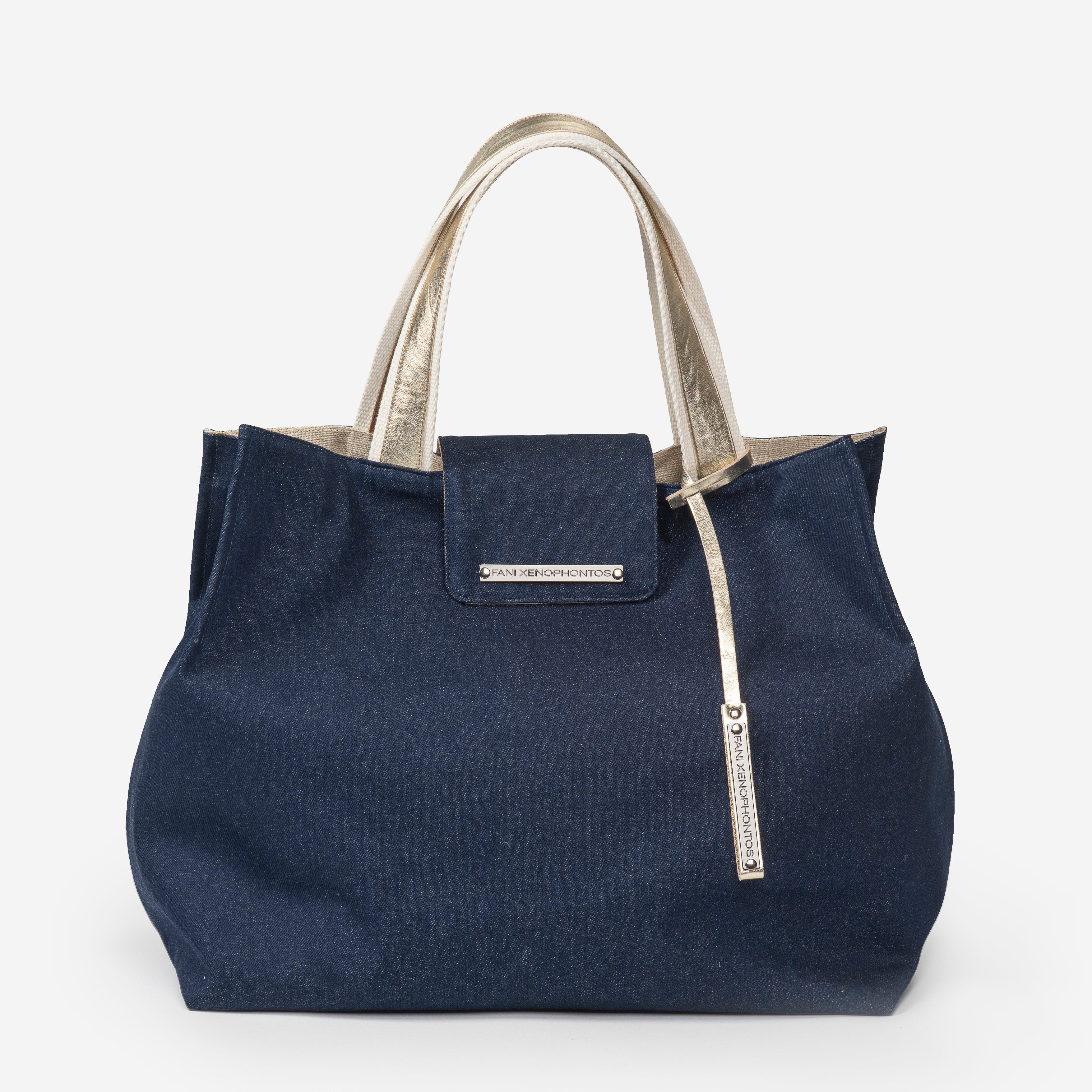 Navy blue tote bag with silver accents on a white background