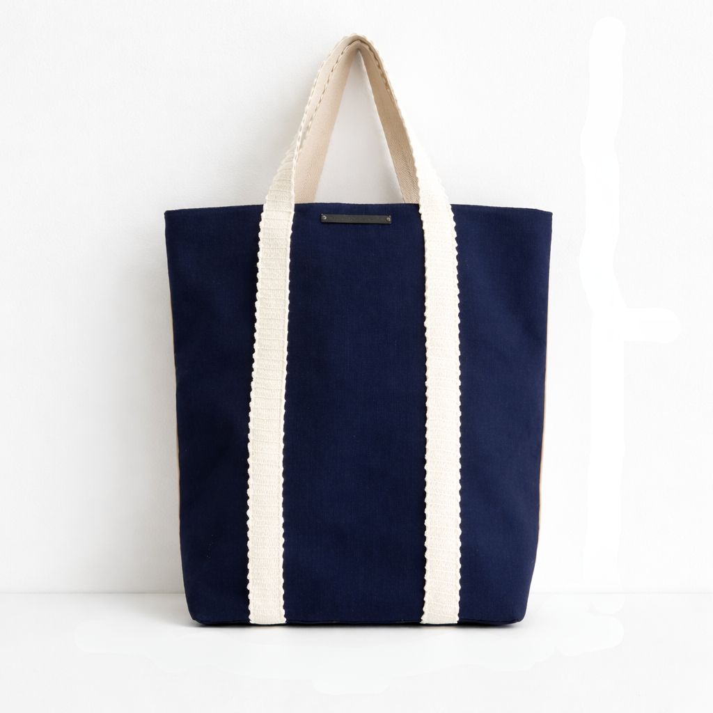 Navy blue beach bag with white stripes on a white background