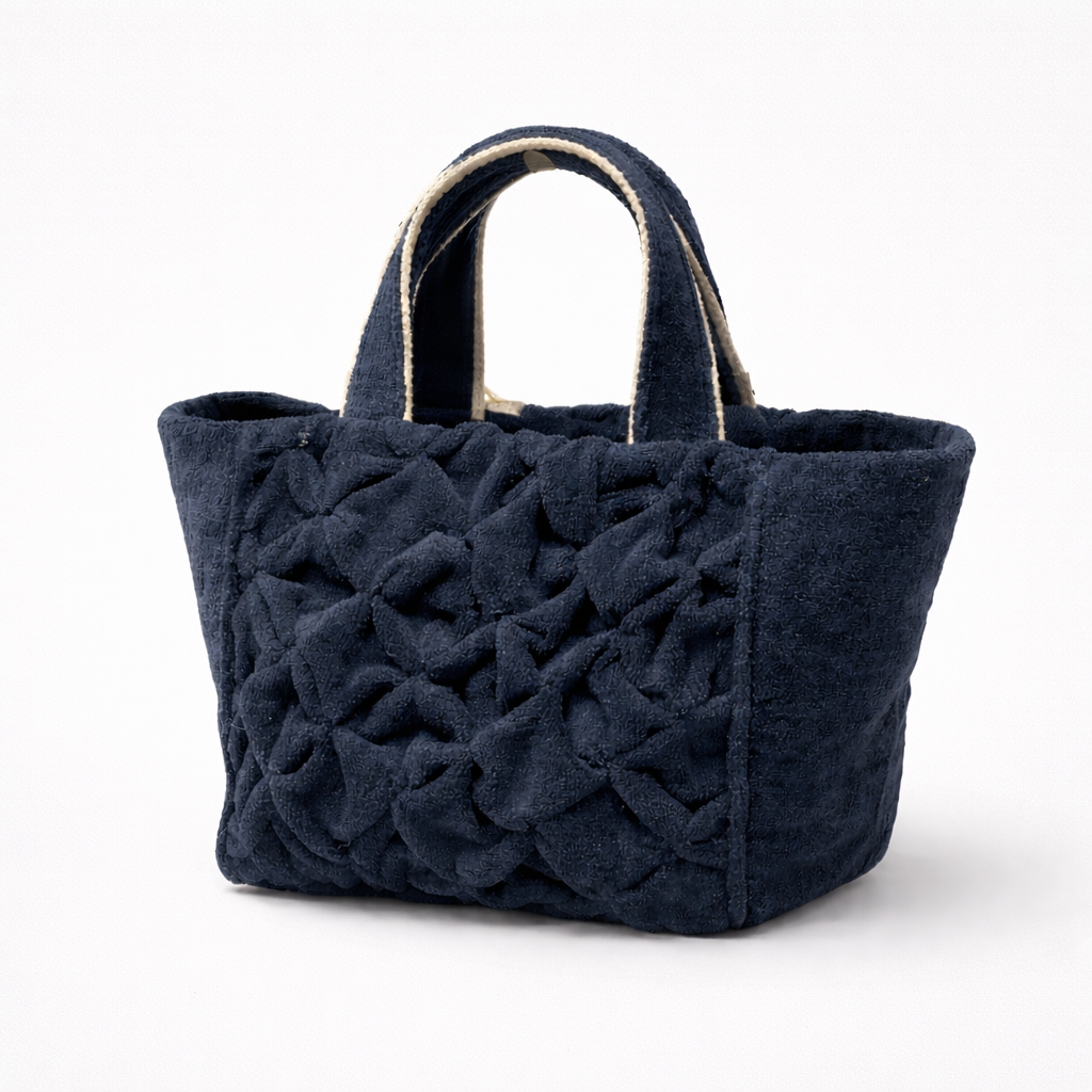 APHRODITE Navy blue textured handbag with braided handle on a white background