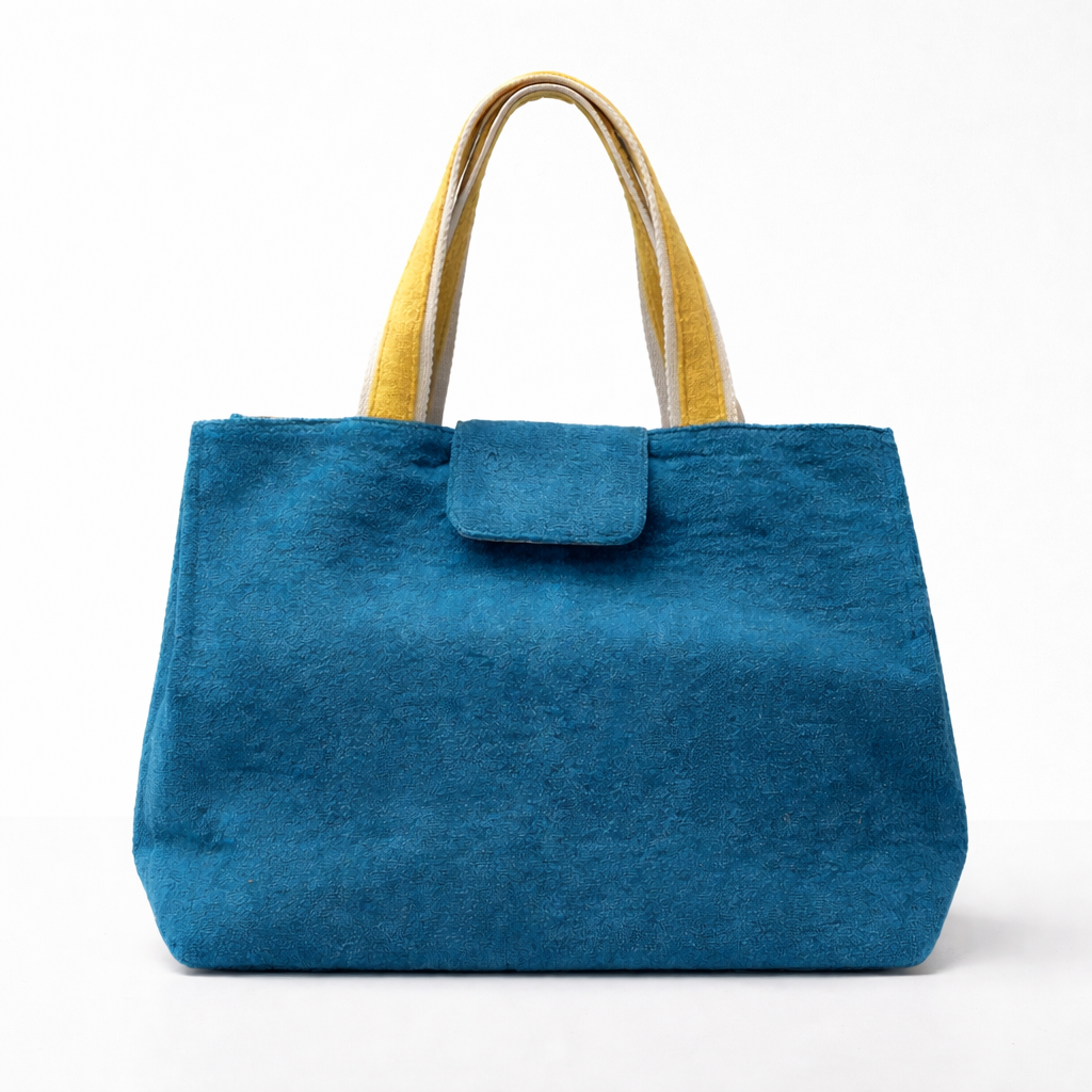 Blue tote bag with yellow handles on a white background